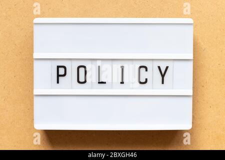 Lightbox with word policy on wood background Stock Photo