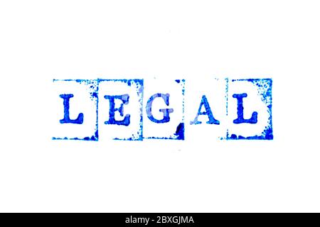 Blue ink of rubber stamp in word legal on white paper background Stock Photo