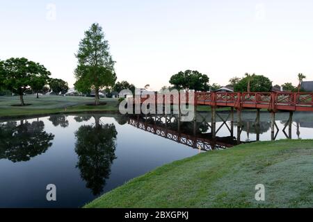 The golf course early morning were trees are mirroring in the lake, Ventura Country Club, Orlando, FL Stock Photo