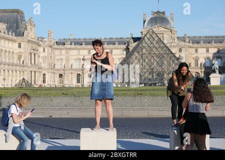Paris, France - September 14, 2019: Female tourists make selfies against Louvre Museum. Louvre Museum is the biggest museum in the world, attracting about 10 million visitors annually Stock Photo