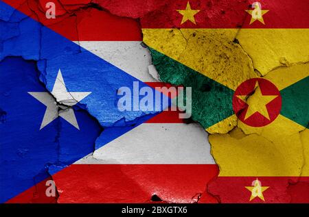 flags of Puerto Rico and Grenada painted on cracked wall Stock Photo