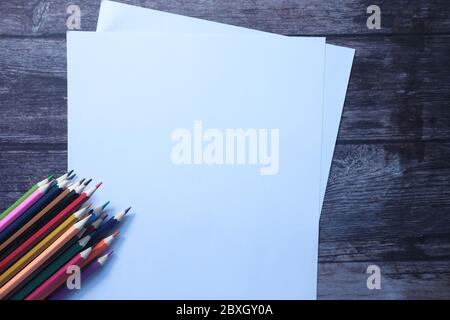 empty paper with color pencils on wooden background  Stock Photo