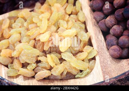 Raisins and nuts on a wooden tray Stock Photo