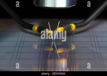 Manual probe system with needles for test of semiconductor on silicon wafer. Selective focus. Stock Photo