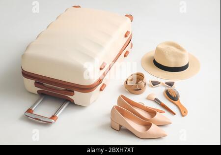 Packed suitcase and accessories on white background Stock Photo