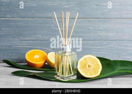 Citrus reed diffuser on wooden table Stock Photo