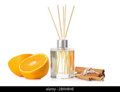 Reed diffuser, orange and cinnamon on white background Stock Photo