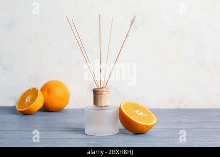 Citrus reed diffuser on wooden table Stock Photo