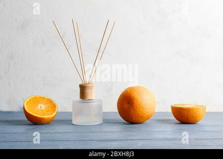 Citrus reed diffuser on wooden table Stock Photo
