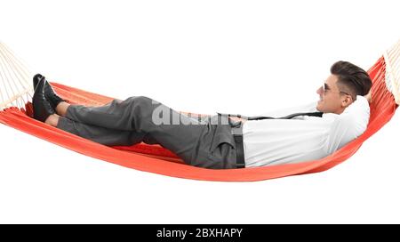 Young businessman relaxing in hammock against white background Stock Photo
