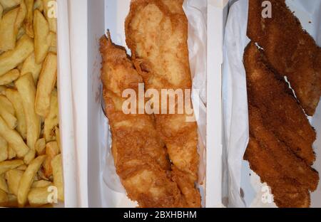 Fish and chips is Britain's national dish Seafood takeaway Large portion of battered fillet with fresh cut fries Haddock is drier and flakier than cod Stock Photo