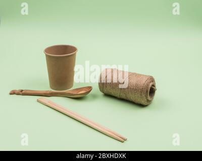 Household items made of ecological materials on a green background. Stock Photo