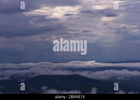 The sun is breaking through the dark clouds as the storm passes. Stock Photo