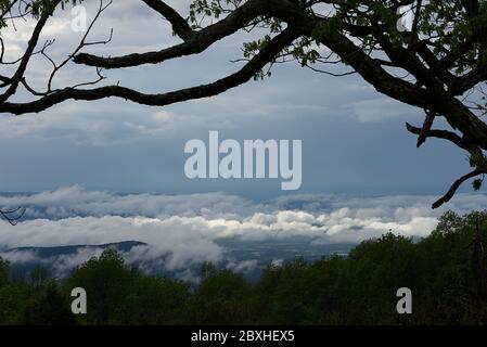 The sun is breaking through the dark clouds as the storm passes. Stock Photo
