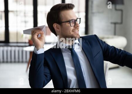 Happy businessman have fun throw plane in office Stock Photo