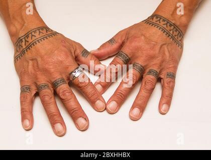 an inuit womans hands with traditional tattoos the markings on her fingers signify flames of an oil lamp