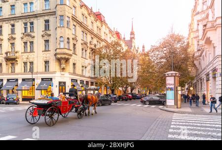 PRAGUE, CZECH REPUBLIC - OCTOBER 17, 2018: Horse carriage tour in Parizska street at Old Town Square in Prague. Tourism in capital city of Czech Republic. Stock Photo