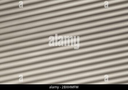 Play of light and shadows, diagonal striped shadows on a white stone wall. Abstact full frame textured background. Stock Photo