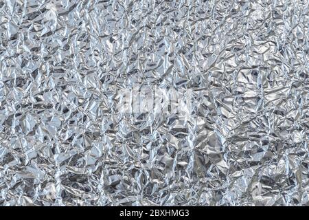 Shiny silver foil close-up. Abstract background, glossy surface Stock Photo  - Alamy