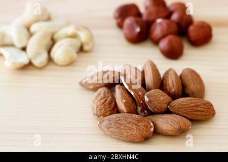 Various nuts on wooden table. Stock Photo