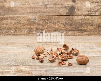 Chopped walnuts on wooden background. Close-up. Shelled nuts. Stock Photo