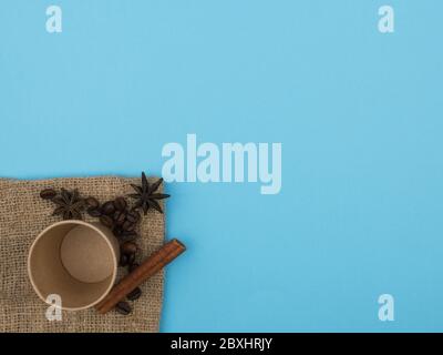 Paper cup, coffee beans and aromatic spices. Stock Photo