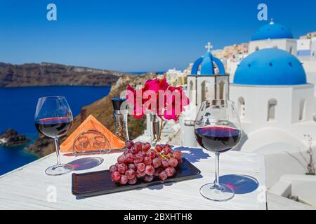 Two glasses of red wine on the background of the sea and Greece Stock Photo
