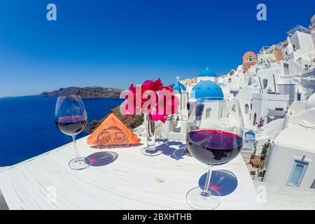 Two glasses of red wine on the background of the sea and Greece Stock Photo