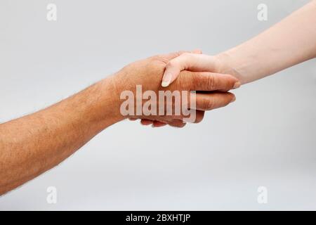 The woman and the man are shaking hands. Idea of friendship Stock Photo