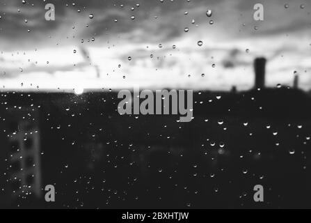 Raindrops on a window pane on a rainy evening Stock Photo