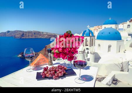 Two glasses of red wine on the background of the sea and Greece Stock Photo