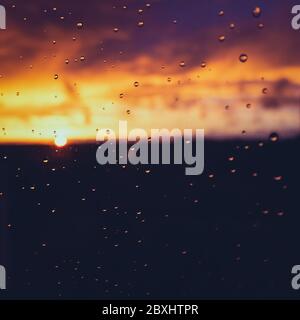 Raindrops on a window pane on a rainy evening Stock Photo