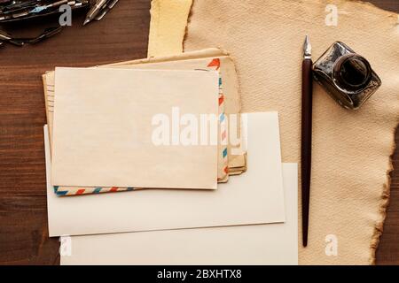 Vintage sheets of paper on wooden table, copy space. Traditional correspondence concept. Stock Photo