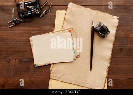 Vintage sheets of paper on wooden table, copy space. Traditional correspondence concept. Stock Photo