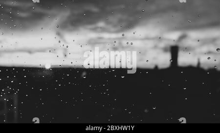 Raindrops on a window pane on a rainy evening Stock Photo