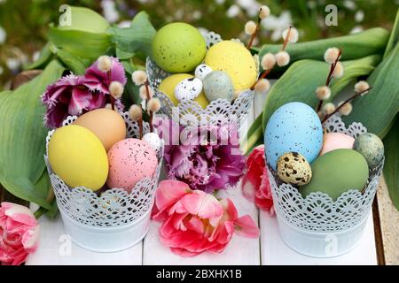 Easter table decoration with tulips and colorful eggs. Festive time Stock Photo