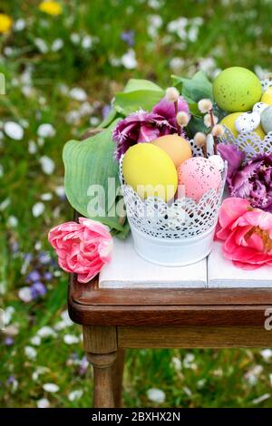 Easter table decoration with tulips and colorful eggs. Festive time Stock Photo