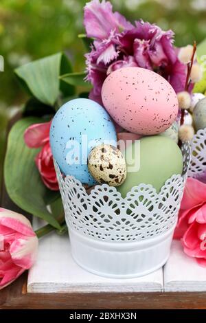 Easter table decoration with tulips and colorful eggs. Festive time Stock Photo
