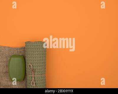 Towel, soap and burlap on an orange background. Stock Photo
