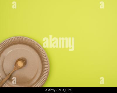 Dishes made of ecologically clean materials on a green background. Stock Photo