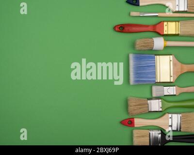 Set of different brushes for painting on a green background. Stock Photo