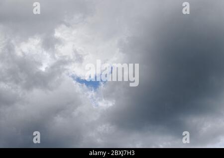 A smile shape hole in the clouds Stock Photo