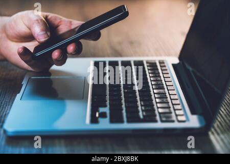 Website developer working using laptop at the office on wooden Stock Photo