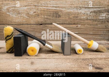 A paint tool for finishing work on wooden background. Stock Photo