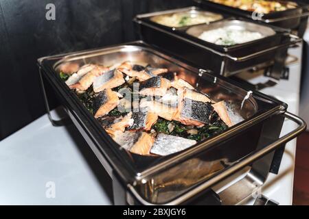 Stainless hotel pans on food warmers with various meals. Roasted meat  pieces with vegetable. Self-service buffet table. Celebration, party,  wedding Stock Photo - Alamy