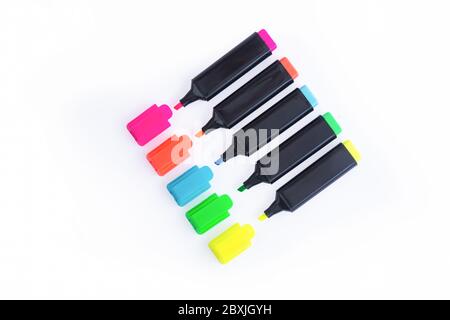 Five Colorful Markers On A White Background, Top View. Arranged in a straight line with Open Caps. Stock Photo