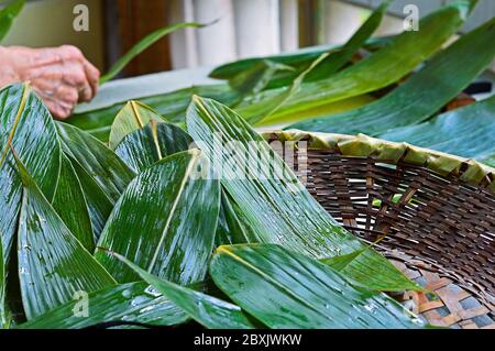 Fresh Leaves Prepared for Making Zongzi, the Traditional Chinese Food Rice Dumplings for Dragon Boat Festival (Duanwu Festival) Stock Photo