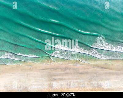 Aerial view of beautiful beach with repetition line of waves. Stock Photo