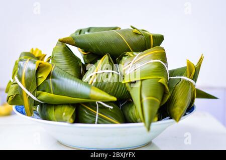 Zongzi Isolated against white background. Zongzi is the traditional Chinese rice dumplings for Dragon Boat Festival (Duanwu Festival). Stock Photo