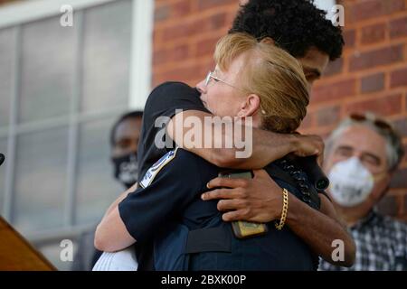 UNITED STATES - June 7, 2020: Purcellville Police Chief Cynthia McAlister is hugged by former Loudoun Valley student Joshua Fox who had given an impas Stock Photo